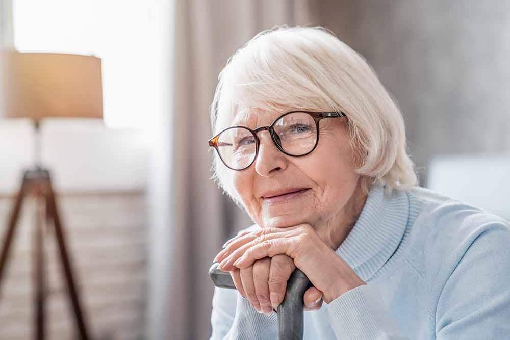 woman leaning on her walking stick