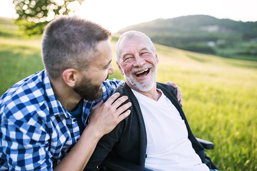 carer on a walk with elderly man